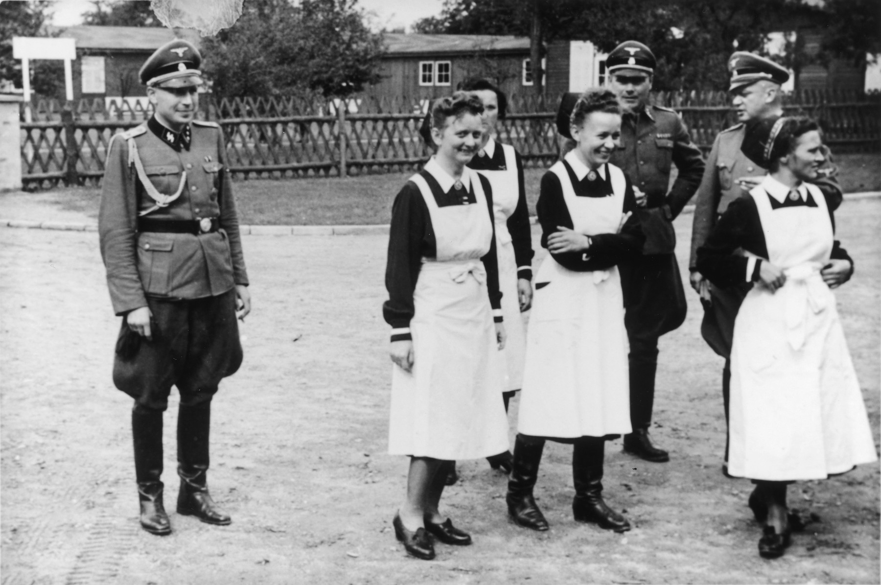 SS officers and German nurses gather during the dedication ceremony of the new SS hospital in Auschwitz.